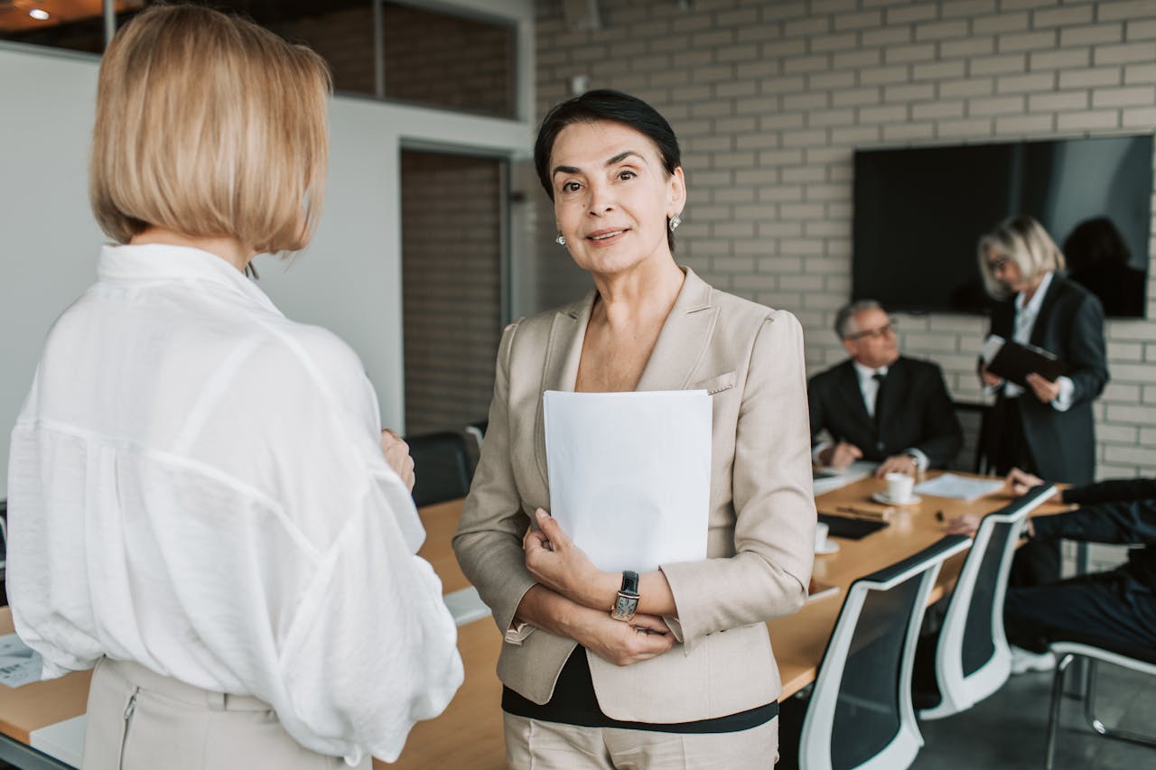 Crafting Captivating Headlines: Your awesome post title goes here Senior businesswoman smiling and holding documents during a corporate meeting indoors.