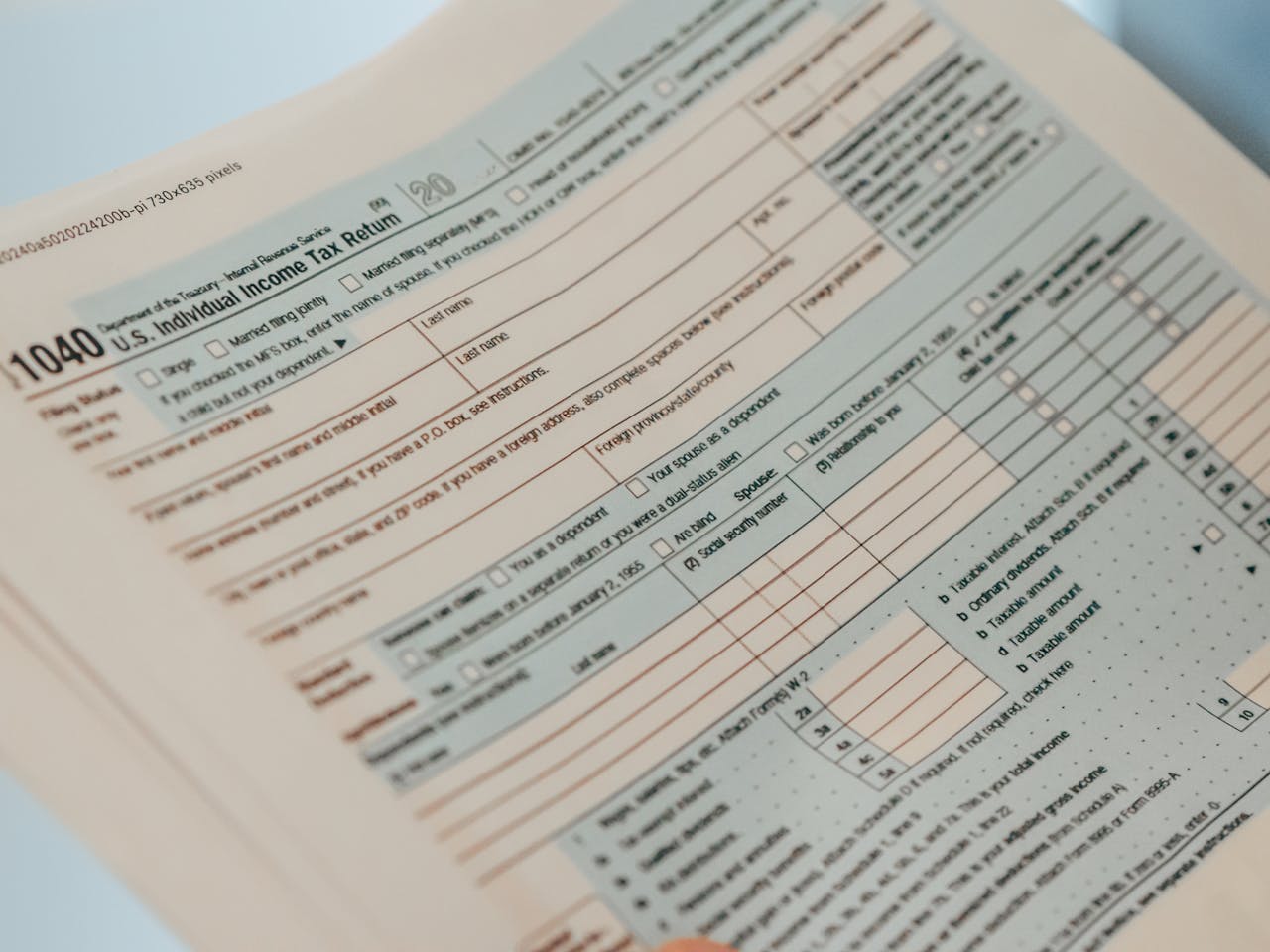 our-journey-03 Detailed close-up image of a U.S. 1040 Individual Income Tax Return form, ideal for finance-related content.